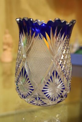 un vase en verre bleu posé sur une table en verre