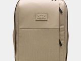 the backpack is beige and has a zipper on the front