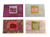 four cards with different designs on them on a white surface