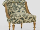 une chaise rembourrée dont le dossier et les pieds sont recouverts d'un tissu à motifs floraux