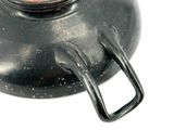 a black pot with a lid on a white surface