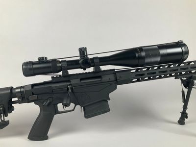 a rifle with a scope mounted on top of it