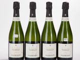three bottles of champagne are lined up on a white surface