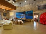 an image of a living room with a large painting on the wall