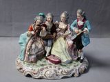 a figurine of a group of people sitting on a table