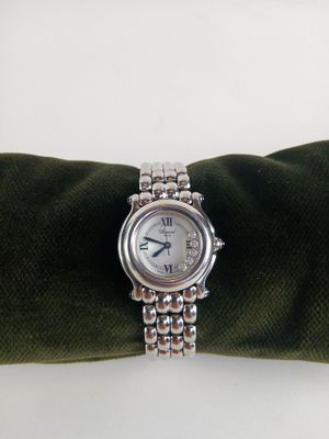 une montre en argent posée sur une serviette verte
