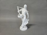 figurine of a woman with a basket of flowers in her hand