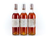 three bottles of wine sitting next to each other on a white surface