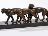 statue of a group of lions walking on a black base