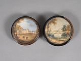 pair of miniature paintings of a house and a park on a table