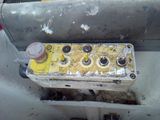 a dirty old car with a yellow and black engine