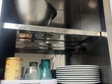 a metal shelf with plates and bowls on it