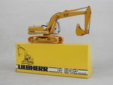 a toy excavator sitting on top of a yellow box