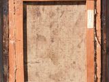 an old picture frame with a piece of wood in it