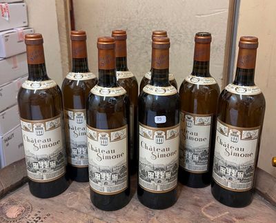 six bottles of wine are lined up in a row on a counter