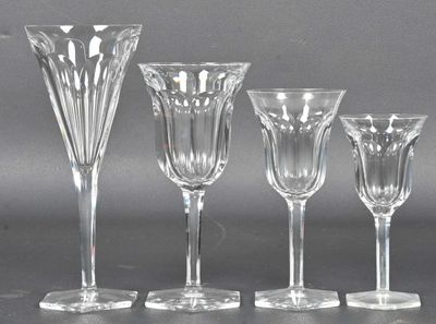 quatre verres à vin et un vase posés sur une table