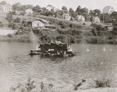 black and white photo of a small boat on a river
