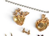 a necklace, earring, and ring with a picture on it