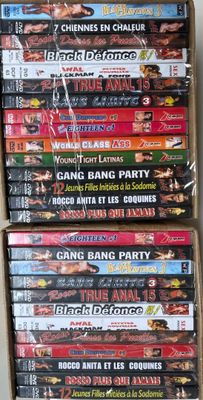many dvds are stacked on top of each other in a box