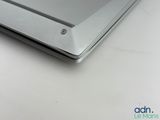 the back end of a laptop computer sitting on top of a white table