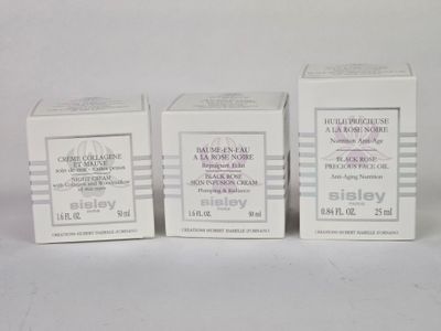 three boxes of skin care products sitting on a white surface