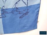 a blue and white scarf with a drawing of a man on a horse