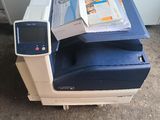 a blue and white printer sitting on top of a white table