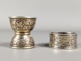 pair of silverplated cups with floral designs on the sides