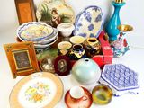 many different types of vases and plates on the table