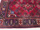 rug on the floor is red and blue with a pattern on it