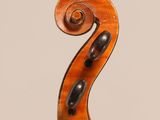 an old violin with a wooden back and a long neck