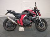 a picture of a red and black motorcycle parked in a garage
