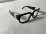 glasses on a white surface with a black frame and clear lens