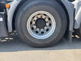a close up of a truck tire on the road