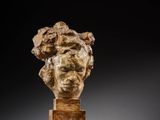an image of a sculpture of a woman ' s head on a wooden stand