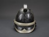 an old helmet with goggles on a gray background