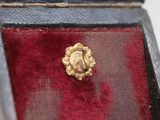 an image of a gold ring in a red velvet box