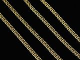 a close up of a gold chain on a black background
