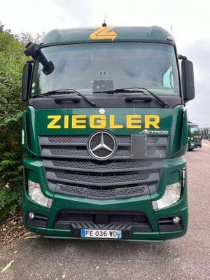 a green truck that is parked on the side of the road