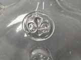a clear glass vase with a decorative design on it