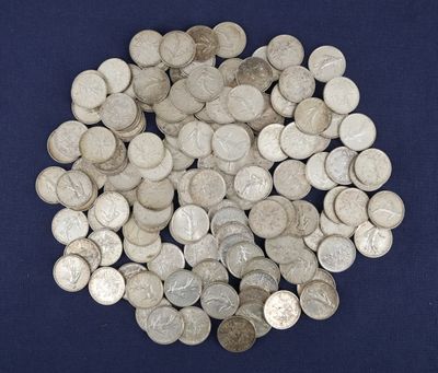 a pile of silver coins on a blue surface