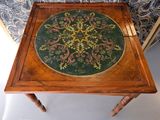 a wooden table with a green and yellow design on it