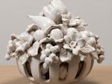 a white vase that has a bunch of flowers in it