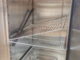 an empty refrigerator with the door open on the floor