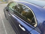 a blue car parked in a parking lot next to a parking meter