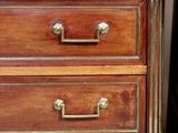 an image of a wooden dresser with marble top