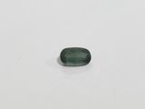 a green tourmaline stone on a white surface
