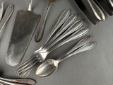 a lot of silver spoons and forks on the table