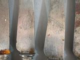 five knives that are sitting next to each other on a table