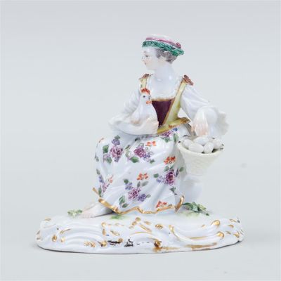 an image of a figurine of a woman with a basket of flowers